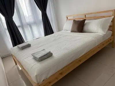 a bed with two pillows on it in front of a window at Skyhomes KLCC New in Kuala Lumpur