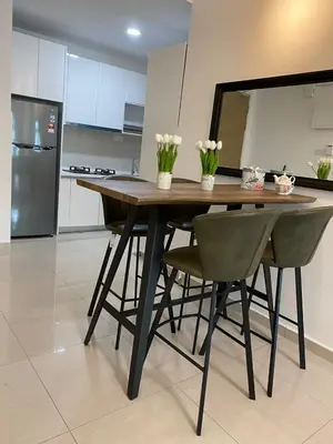 a kitchen with a table and chairs with flowers on it at Skyhomes KLCC New in Kuala Lumpur