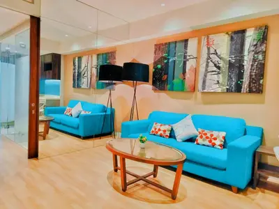 a living room with two blue couches and a table at Lila Suites D, Majestic Place in Kuala Lumpur