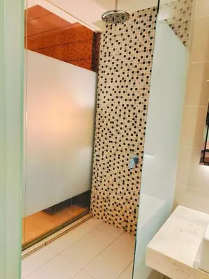 a shower with a glass door in a bathroom at Lila Suites D, Majestic Place in Kuala Lumpur