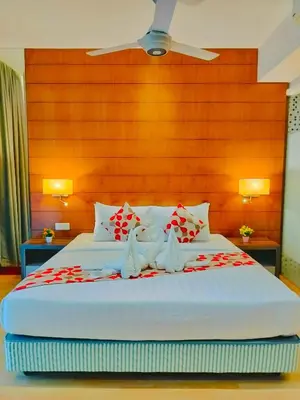 a bedroom with a large bed with a red wall at Lila Suites D, Majestic Place in Kuala Lumpur
