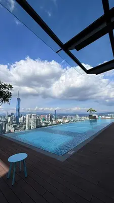 a swimming pool with a view of a city at Riveria Suites, KL Sentral by Homebrickz in Kuala Lumpur