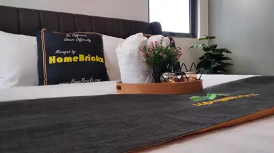 a bed with a pillow with a stuffed animal on it at Riveria Suites, KL Sentral by Homebrickz in Kuala Lumpur