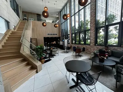 a lobby with a staircase and a person sitting on a couch at THE COLONY INFINITUM Sweet Home SR in Kuala Lumpur