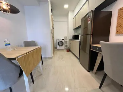 a small kitchen with a table and a refrigerator at THE COLONY INFINITUM Sweet Home SR in Kuala Lumpur