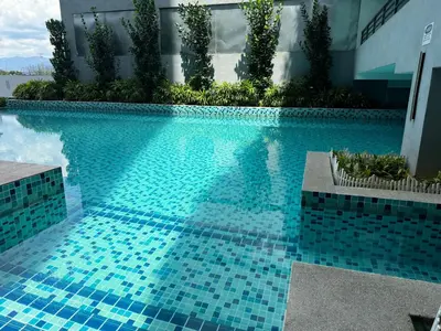 a reflection of a person in a swimming pool at KL City Nue Suites Entire Condo 2R2B 3 plus 1 guests in Kuala Lumpur