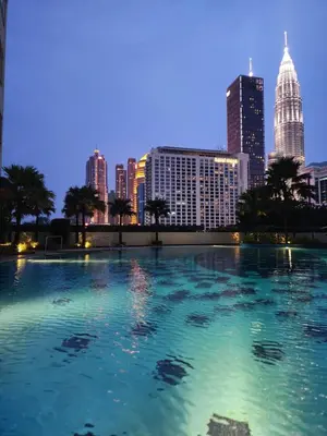 a large pool with a city skyline in the background at 4R2B crest residences walk to klcc jln alor train 2station to bukitbintang water machine in Kuala Lumpur