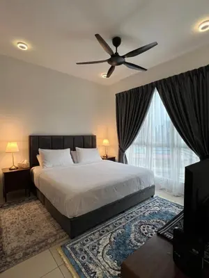 a bedroom with a bed and a ceiling fan at Casa Dbandar in Kuala Lumpur
