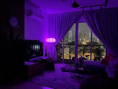 a purple living room with a view of a city at Casa Dbandar in Kuala Lumpur