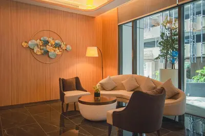 a living room with a couch and chairs and a table at Imperial KLCC by Opus Hospitality in Kuala Lumpur