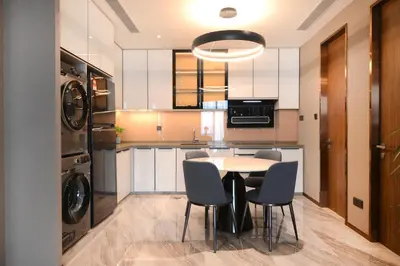 a kitchen with a table and chairs in a kitchen at Imperial KLCC by Opus Hospitality in Kuala Lumpur