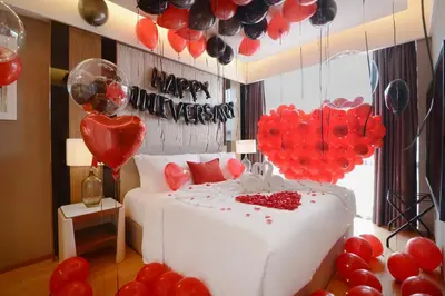 a bedroom with a bed with red and black balloons at Imperial KLCC by Opus Hospitality in Kuala Lumpur