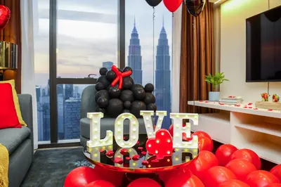 a room with a sign that says love and balloons at Imperial KLCC by Opus Hospitality in Kuala Lumpur