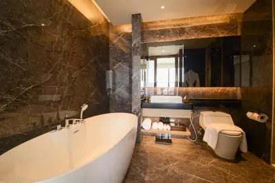 a bathroom with a tub and a toilet and a sink at Imperial KLCC by Opus Hospitality in Kuala Lumpur