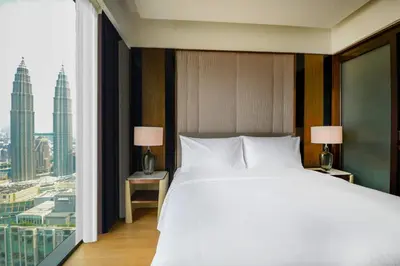a bedroom with a large bed and a large window at Imperial KLCC by Opus Hospitality in Kuala Lumpur