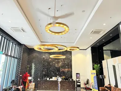 a lobby with a large chandelier in a building at Chambers Skylight Sernity Suites KLCC in Kuala Lumpur