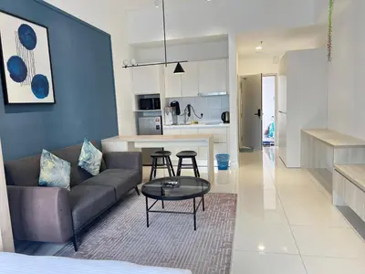 a living room with a couch and a table at Chambers Skylight Sernity Suites KLCC in Kuala Lumpur