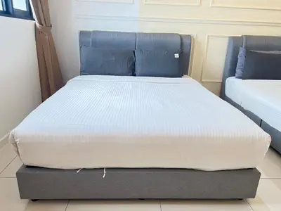 a bed in a room with a mattressvisor at Chambers Skylight Sernity Suites KLCC in Kuala Lumpur