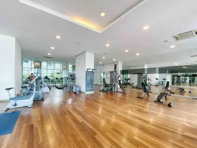 a gym with treadmills and exercise equipment in a room at Regalia by sweet home in Kuala Lumpur