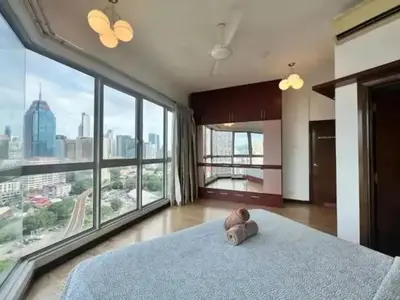 a bedroom with a bed with a stuffed animal on it at Regalia by sweet home in Kuala Lumpur
