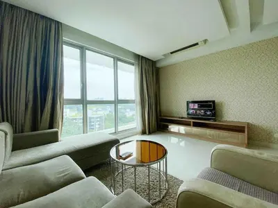 a living room with a couch and a table at Regalia by sweet home in Kuala Lumpur
