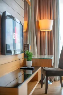 a living room with a tv and a chair and a table at Dua Sentral 2km to KL Sentral in Kuala Lumpur