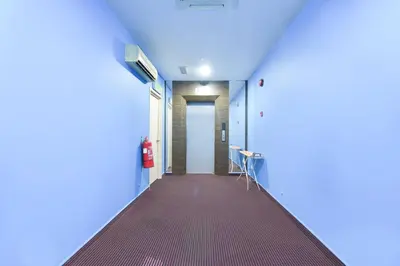 a hallway of a hospital with a red carpet at Hotel O Pollodium Chinatown in Kuala Lumpur