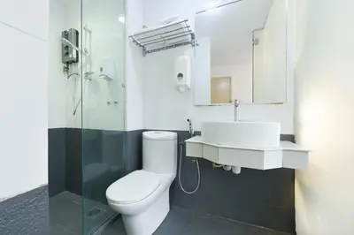 a bathroom with a toilet and a sink and a shower at Hotel O Pollodium Chinatown in Kuala Lumpur