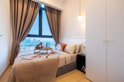 a bedroom with a bed and a large window at KidsVille Shamelin Star KLCC View Infinity Pool in Kuala Lumpur