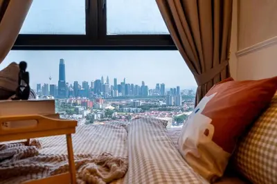 a room with a window with a view of a city at KidsVille Shamelin Star KLCC View Infinity Pool in Kuala Lumpur