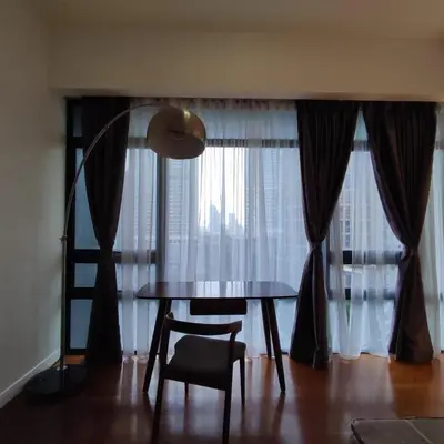 a dining room table and chair in front of a window at Anggun residence studio klcc in Kuala Lumpur