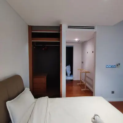 a bedroom with a white bed and a bathroom at Anggun residence studio klcc in Kuala Lumpur
