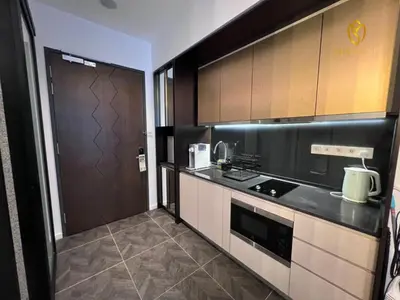 a kitchen with a stove top oven next to a door at Scarletz Suites KLCC by Minshuku in Kuala Lumpur