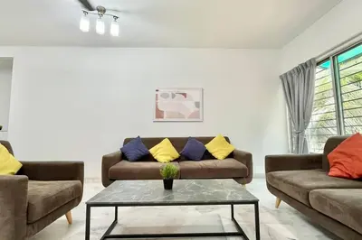 a living room with two couches and a table at 3BR Family Stay at Desa Pandan KL ready Wifi Netflix in Kuala Lumpur