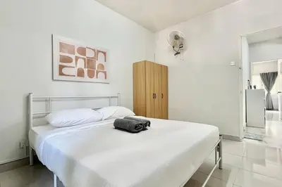 a white bedroom with a bed with a bag on it at 3BR Family Stay at Desa Pandan KL ready Wifi Netflix in Kuala Lumpur