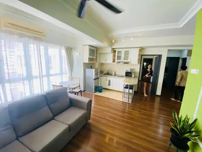 a living room with a couch and a kitchen at place to stay At Bukit Bintang in Kuala Lumpur