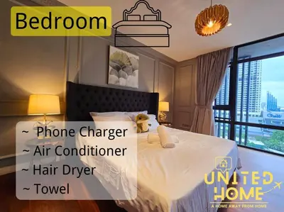 a bedroom with a bed with a white comforter at Anggun Residence near KLCC Serviced Suite in Kuala Lumpur