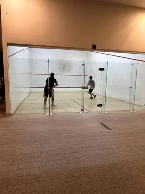 two men playing a game of volleyball in a glass wall at Regalia KLCC View by Ucare Suites in Kuala Lumpur