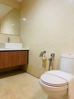 a bathroom with a white toilet and a sink at Regalia KLCC View by Ucare Suites in Kuala Lumpur
