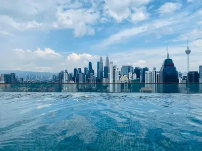 a view of a city skyline from a swimming pool at Regalia KLCC View by Ucare Suites in Kuala Lumpur
