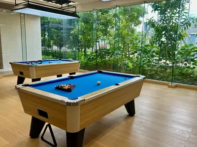 two pool tables in a room with a large window at KL Sentral 28th Floor CityCenter in Kuala Lumpur