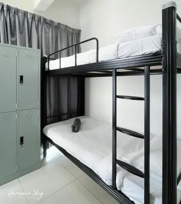 a bunk bed with a cat laying on the bottom bunk at Awesomestay Hostel near KLCC , walk to PWTC PUTRA in Kuala Lumpur