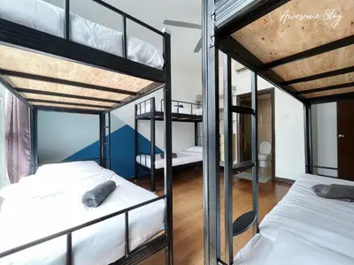 a room with three bunk beds in a room at Awesomestay Hostel near KLCC , walk to PWTC PUTRA in Kuala Lumpur