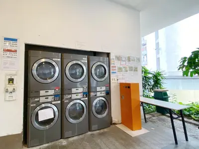 a group of four washing machines in a room at Awesomestay Hostel near KLCC , walk to PWTC PUTRA in Kuala Lumpur