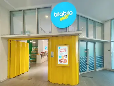 a store with yellow doors and a sign on it at Awesomestay Hostel near KLCC , walk to PWTC PUTRA in Kuala Lumpur