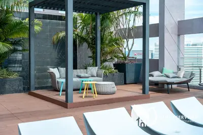 a patio with couches and tables on a building at Riveria City at KL Sentral by Plush in Kuala Lumpur