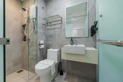 a bathroom with a toilet and a sink and a mirror at Riveria City KL Sentral by Sleepy Bear in Kuala Lumpur