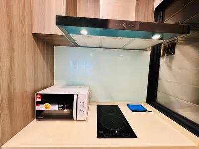a kitchen with a microwave and a stove at Velocity Residence linkway Sunway mall in Kuala Lumpur