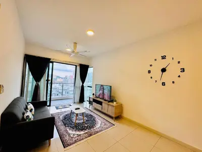 a living room with a clock on the wall at Velocity Residence linkway Sunway mall in Kuala Lumpur