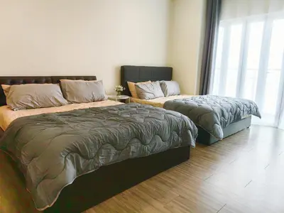 a bedroom with two beds and a window at Setapak Central KL - Zetapark Spring Suites in Kuala Lumpur